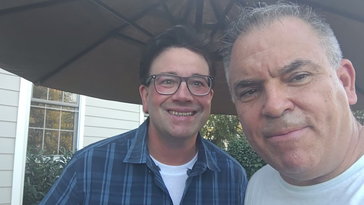Dean Vagnosi and Tony Costello on a patio, recording a video